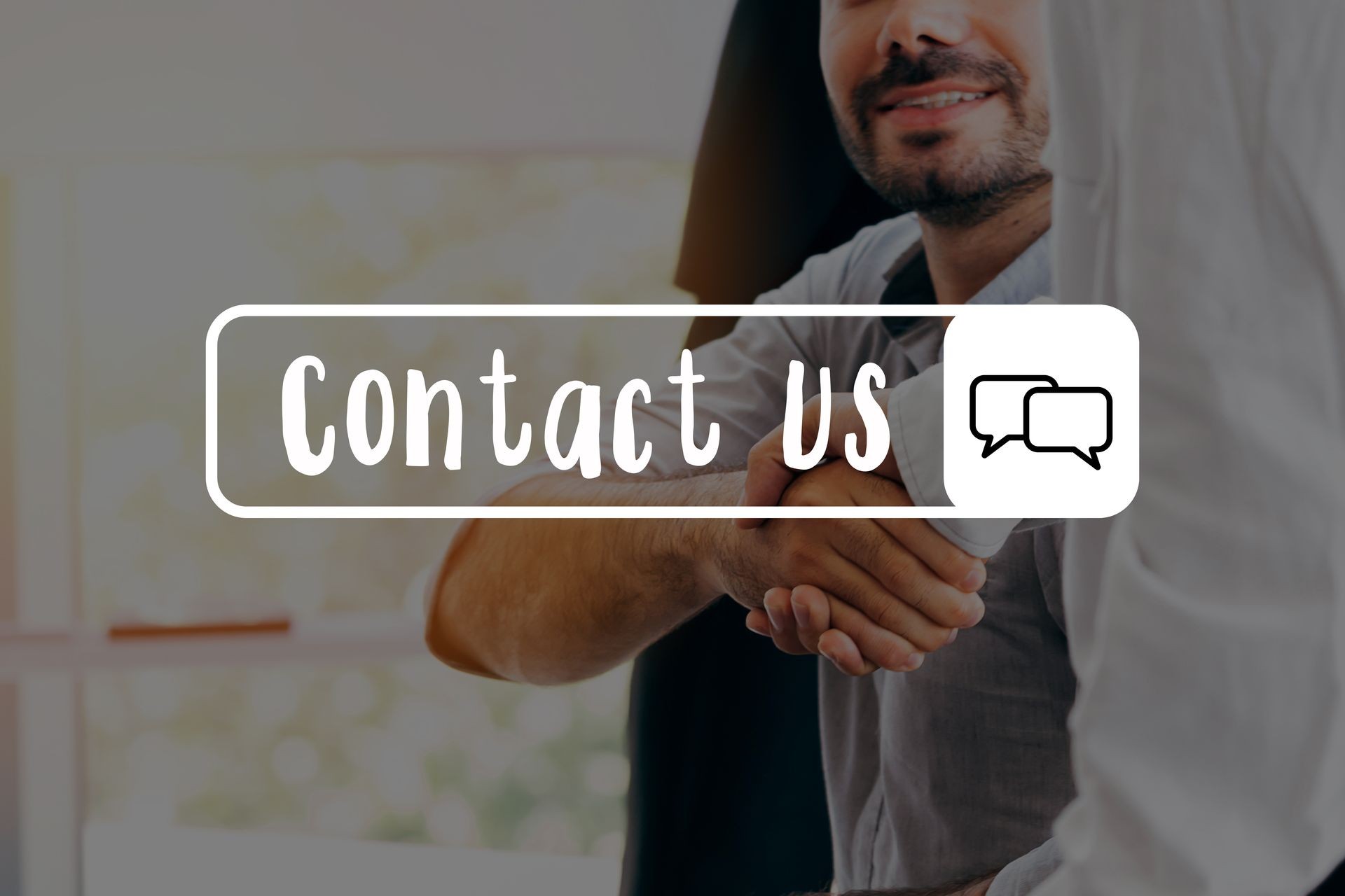 Businessmen shaking hands together in office in background - with Contact Us message Businessmen shaking hands together in office in background - with Contact Us message